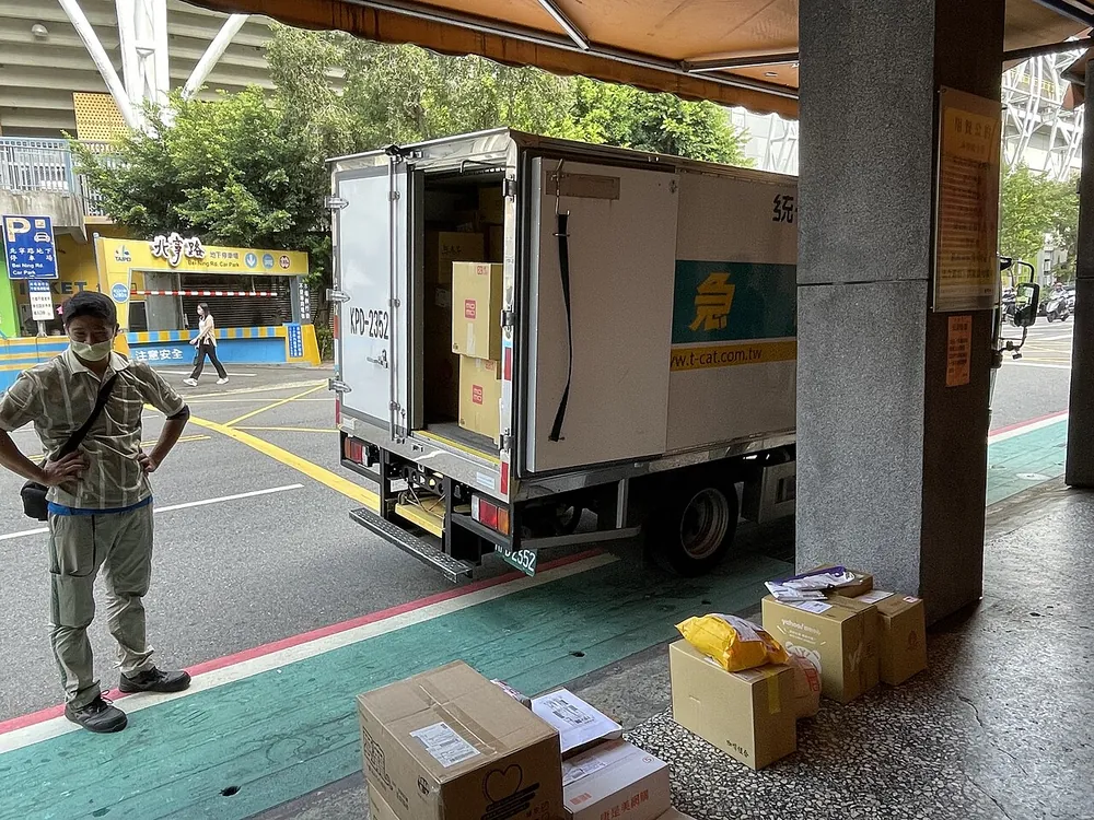 Couriers arranging parcels for final delivery after international shipping