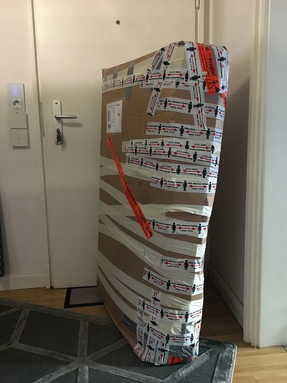 A parcel being packed with fragile handling labels
