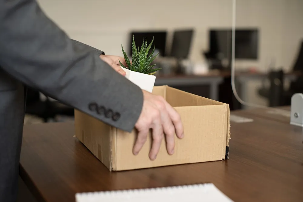 Employee packing items into a cardboard box